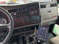 Interior view of a 2013 Kenworth T370 showing the dashboard with gauges multimedia display and controls