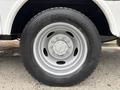 Close-up of a wheel from a 2018 Ford F-550 featuring a silver rim and a black tire with visible tread pattern