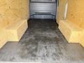 Interior of a 2022 Mercedes-Benz Sprinter van with wooden storage boxes on either side and a flat metal floor
