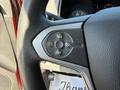 Steering wheel controls of a 2018 GMC Canyon featuring buttons for cruise control with plus and minus signs as well as a set and resume function