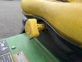 Close-up of a yellow keyed ignition switch on the seat of a 2009 John Deere 2653B Precision Diesel Mower