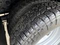 Close-up of two heavily treaded tires from a 2015 Ford F-350 displaying wear and dirt on the surface