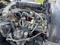The image shows the engine components of a 2014 Hino 195 including various pipes wires and fittings with a prominent metallic structure in the center