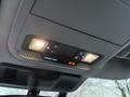 Interior overhead control panel of a 2023 Ford F-250 with lights and indicator buttons for passenger airbag status