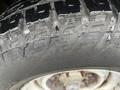 Close-up of a tire on a 2009 Ford Econoline showing tread pattern and water droplets on the surface
