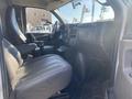 Interior view of a 2011 Chevrolet Express showing a driver's seat dashboard and controls with gray upholstery