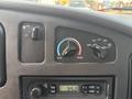 Dashboard controls of a 2008 Ford Econoline featuring fan speed dial temperature control and radio display