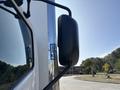 A 2018 Hino 195 truck with a prominent side view mirror reflecting the vehicle's exterior details