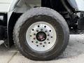 Close-up of a large Goodyear tire mounted on a 2014 International 7500 truck with visible tread and metallic rim