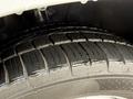 Close-up of a tire from a 2020 Mercedes-Benz Metris showing a wet tread pattern with water droplets on the surface