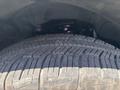 Close-up of a tire with detailed tread patterns and a portion of the wheel well of a 2017 Chevrolet Colorado visible behind it