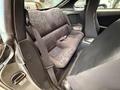 Interior view of a 1997 Toyota Supra showing the rear seats with fabric upholstery and seatbelts