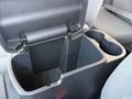 An open center console in a 2013 Toyota Tacoma revealing storage space with two cup holders on the right side