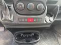 The interior controls of a 2017 RAM Promaster including buttons for air conditioning hazard lights and a cup holder