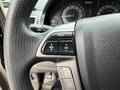 Close-up of the steering wheel of a 2014 Honda Odyssey featuring buttons for volume channel and mode control