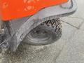 Close-up of the rear tire of a 2010 Kubota RTV 900 showing a rugged tread pattern and textured fender