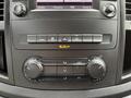 A close-up view of the dashboard controls in a 2020 Mercedes-Benz Metris featuring climate control knobs and a display screen with radio settings