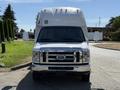 Front view of a 2013 Ford Econoline van featuring chrome grille and large side mirrors
