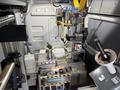 A 2023 Ford Transit with a custom interior featuring a compact industrial machine setup with controls, tools, and work surfaces designed for specific tasks