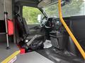Interior of a 2020 Chevrolet Express showing the driver's seat dashboard and controls with a step and grab handle visible