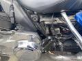 A 2017 Harley-Davidson FLHTKL motorcycle engine and chrome detailing with a focus on the black seat and electrical components