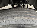 Close-up of a tire from a 2023 Ford F-450 Super Duty showing tread patterns and grooves