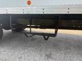 A close-up view of the undercarriage of a 2012 Hino 338 showing a steel support frame and an exposed drive shaft