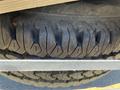 A 2013 Chevrolet Silverado 1500 tire showing tread pattern with distinct grooves and ridges