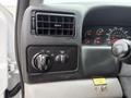 Interior dashboard control panel of a 2004 Ford F-750 featuring ventilation vents and various knobs and switches for lights and panel settings