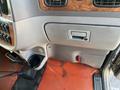 Interior dashboard of a 2009 Peterbilt Highway featuring controls storage compartment and cup holder with an orange floor mat