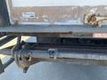 A rusty rear view of a 2014 International TerraStar truck showing the hitch and tailgate mechanism