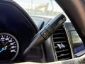 Close-up of a 2021 Ford F-250 SD steering wheel with a gear shift lever labeled Drive Mode featuring a plus and minus button for gear selection