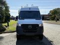 Front view of a 2023 Mercedes-Benz Sprinter 2500 with a white cab and black grill showcasing the iconic Mercedes logo