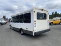 A white 2020 Chevrolet Express van with several side windows and a rear ramp accessible design