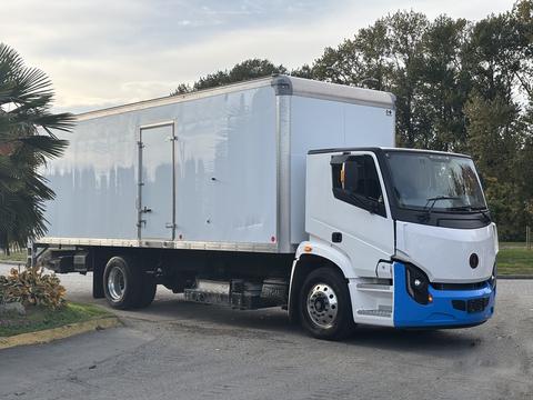 A 2022 Lion Lion6 electric truck with a white cargo box and blue accents parked at an angle, showcasing its modern design and smooth lines