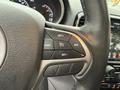Close-up of the steering wheel controls in a 2019 Jeep Grand Cherokee featuring buttons for setting cruise control and adjusting speed