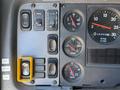 Control panel of a 2004 American LaFrance Eagle featuring various switches and gauges for oil water and volt readings