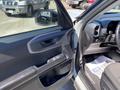 2023 Ford Bronco Sport interior with a focus on the driver's side door and control panel featuring window controls and a side mirror adjustment knob