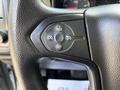 Close-up of a steering wheel control panel featuring buttons for setting cruise control and adjusting settings on a 2020 Chevrolet Silverado