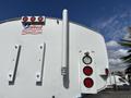 A 2016 Ford F-750 rear view with red tail lights a silver exhaust pipe and a white water tank adorned with a United logo