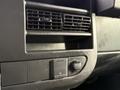 Interior dashboard of a 2015 GMC Savana showing air vents a power outlet and control knobs