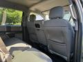 Interior view of the rear seats of a 2018 Ford F-150 with gray fabric upholstery and seatbelts visible