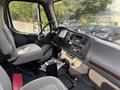 Interior view of a 2010 Freightliner M2 106 showing the driver's seat dashboard and controls