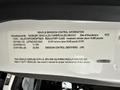 Label detailing vehicle emission control information for a 2021 Freightliner M2 106 including VIN regulatory class and emission control identifiers
