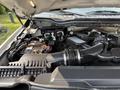 The engine compartment of a 2020 Ford F-350 SD featuring the engine components battery and air intake system