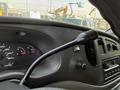 Close-up of the dashboard of a 2008 Ford Econoline featuring the gear shift lever and instrument cluster with gauges for speed and temperature