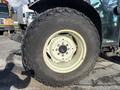 A large tire from a 2010 New Holland T4050 tractor showing deep tread and a multi-bolt wheel hub
