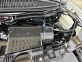 Engine compartment of a 2018 Chevrolet Express featuring exposed components including the Vortec engine and various hoses and wires