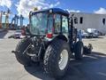 A 2010 New Holland T4050 tractor with a blue and black exterior featuring large tires and a cab with visible controls and windows