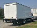 A 2012 Hino 338 box truck with a white cargo area and a black trailer hitch is parked with its rear facing the viewer